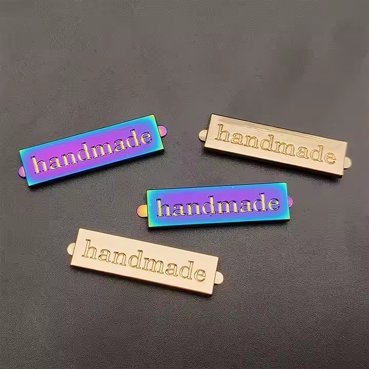 Custom engraved metal tags for fashion handbag branding with logo