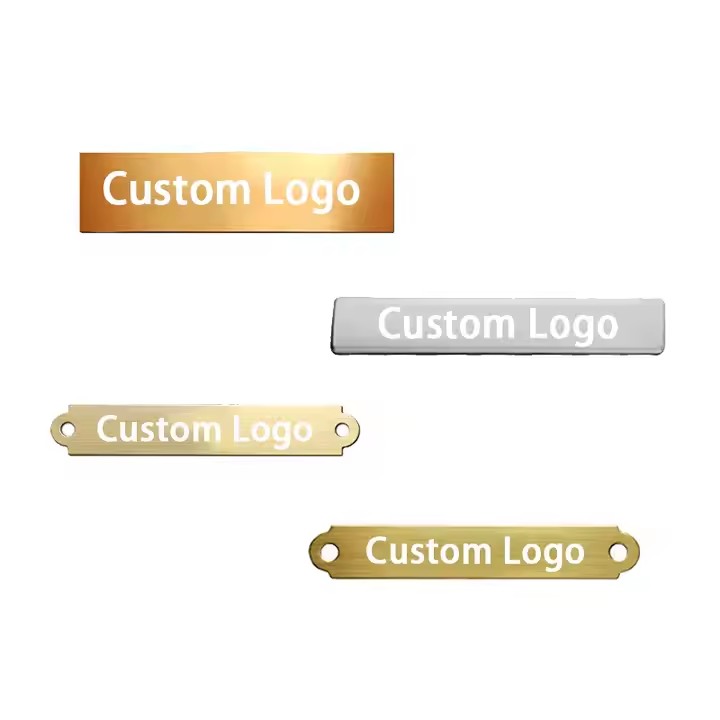 Close-up of a custom 3D engraved metal tag with detailed branding