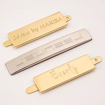 Stylish embossed metal tag with engraved logo for designer handbags