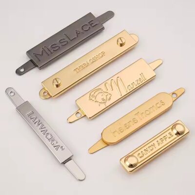 Stylish embossed metal tag with engraved logo for designer handbags