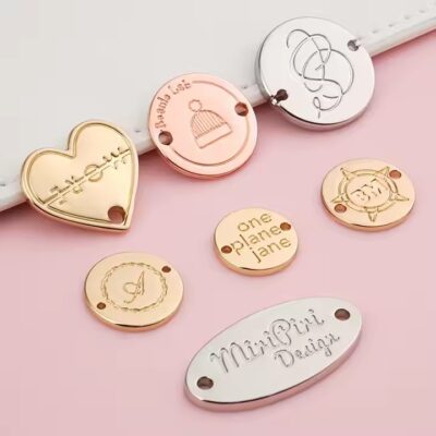 Custom engraved metal tags on swimwear with clear branding and design

