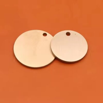 Round brass tag with copper label close-up