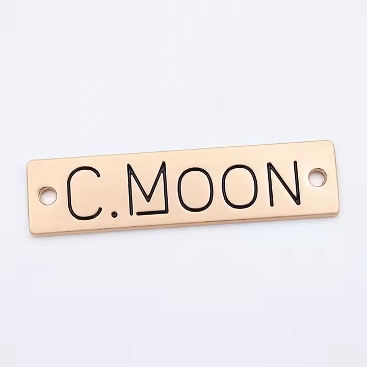 Custom engraved metal tags for branding clothing and apparel items