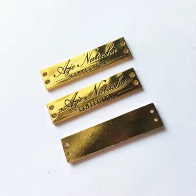 Close-up of stylish engraved metal tags designed for fashion apparel branding