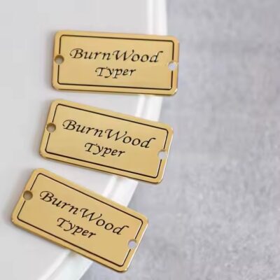 Stylish engraved metal tags attached to fashionable clothing items